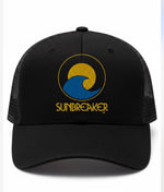 Black trucker cap with 'SUNBREAKER' logo featuring a yellow sun and blue wave on a white background.
